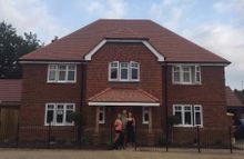 Paul and Cheryl in front of their new home with Cheryl’s daughter Claire and Digby the dog 