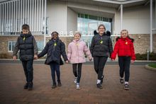 Pupils aged 10 walking together with their new reflective bag tags