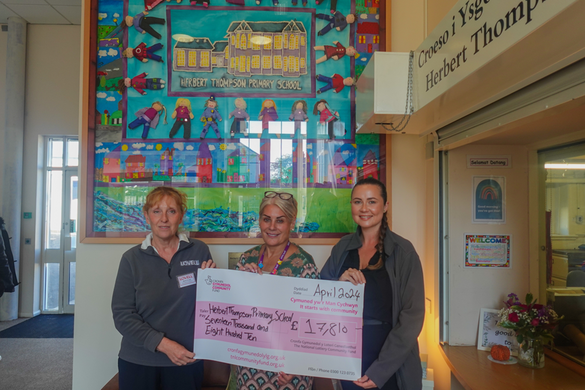 Meriel Gough and Charlotte Holder presenting the cheque at Herbert Thompson Primary School