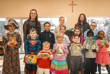 Meg Lowe Marketing Manager at Allison Homes East Midlands, gifting books to children at Cotgrave C of E Primary School