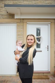 Maddy and Miller outside their brand new home