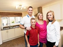 The Boswell family enjoy a cup of tea in their new home