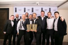 Co-founders Richard Pearce (L) and Tom Carr (R) hold their awards, surrounded by investors and friends of Verto Homes